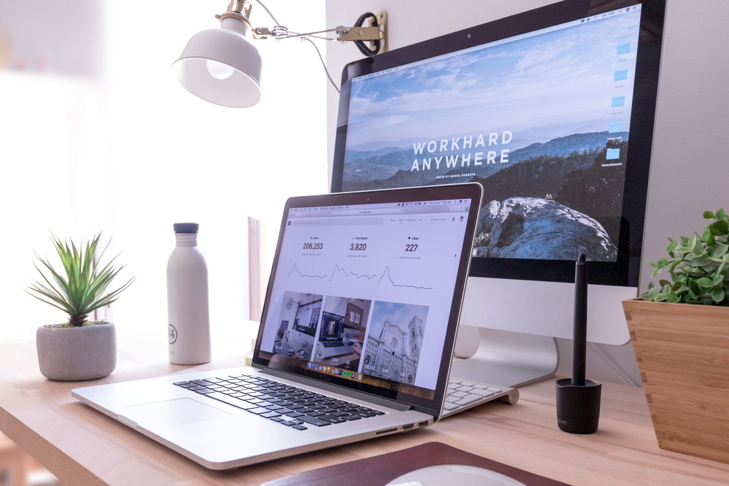 Lap top and Desktop computers on a desk, representing Buying a Website or Online Business