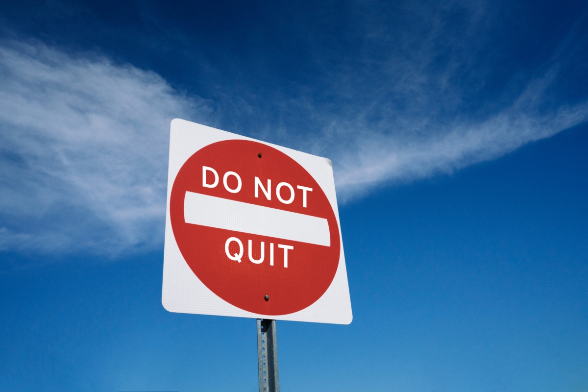 Red "do not quit" street sign; representing keeping your job